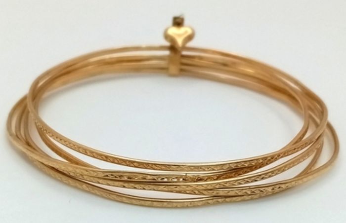A 14K Yellow Gold Bangle Cluster Bracelet.