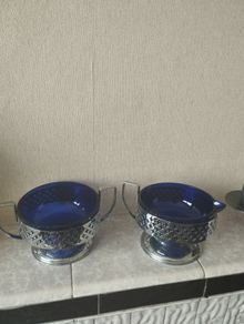 Vintage cobalt blue glass milk jug and sugar bowl with chrome baskets.