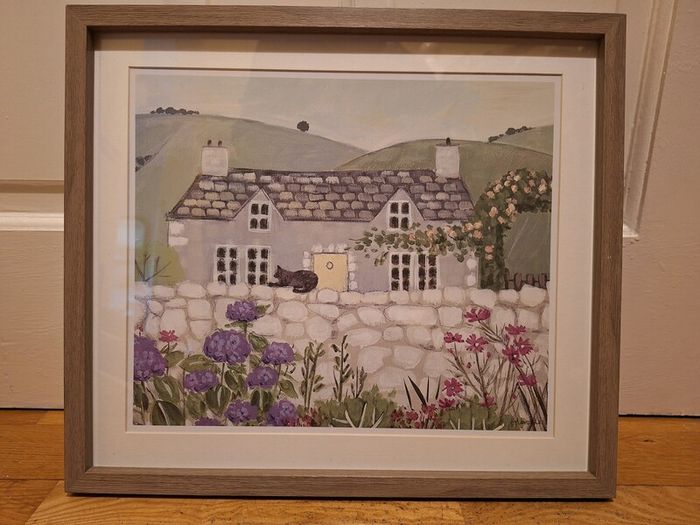 Country Cottage With Cat On Wall Outside