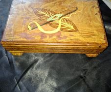 Vintage Wooden Musical Cigar and Cigarette Box, Cigar and Tobacco Leaves on the Lid., when Opened it Plays Music., a beautiful collectors lot,