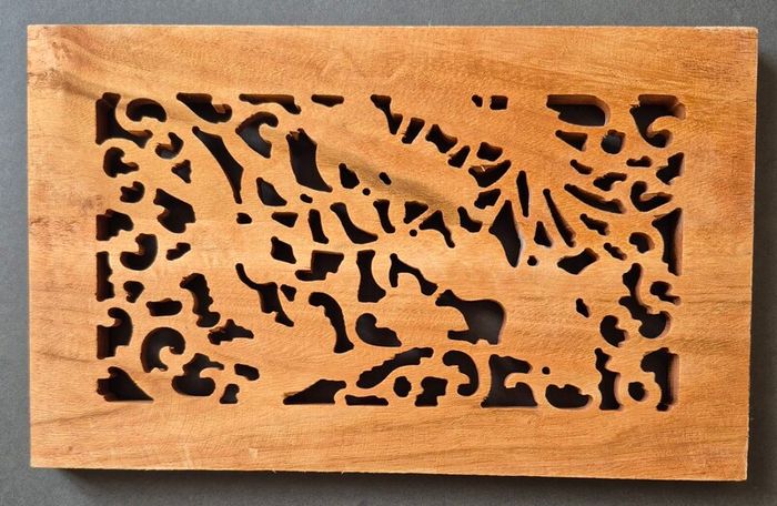 Carved decorative wooden panel, featuring birds.