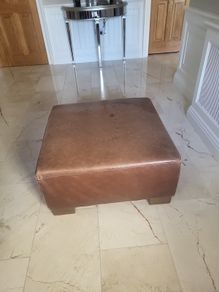 brown leather pouffe