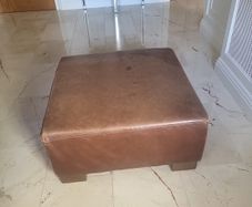 brown leather pouffe