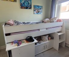 Mid-sleeper bed with pullout desk and underbed cabinet unit.
