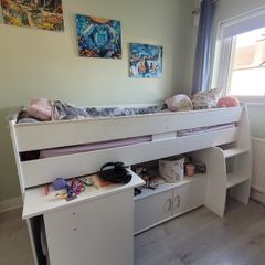 Mid-sleeper bed with pullout desk and underbed cabinet unit.