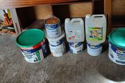 a selection of paint and a paint roller and some good paint brushes