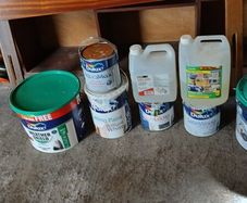 a selection of paint and a paint roller and some good paint brushes