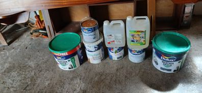 a selection of paint and a paint roller and some good paint brushes