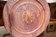 Beautiful vintage hand-carved wooden tray featuring an intricate floral border and a decorative brass inlay geometric star motif in the centre. The craftsmanship is detailed and very tactile, giving this piece a rich, warm character. The tray is solid and