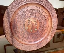 Beautiful vintage hand-carved wooden tray featuring an intricate floral border and a decorative brass inlay geometric star motif in the centre. The craftsmanship is detailed and very tactile, giving this piece a rich, warm character. The tray is solid and