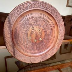 Beautiful vintage hand-carved wooden tray featuring an intricate floral border and a decorative brass inlay geometric star motif in the centre. The craftsmanship is detailed and very tactile, giving this piece a rich, warm character. The tray is solid and