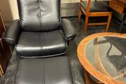 Pair of leather style armchairs with matching footstools