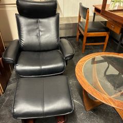 Pair of leather style armchairs with matching footstools