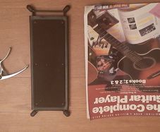 Guitar foot rest, beginners guitar book and guitar capo