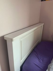 Solid white single bed frame.