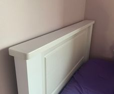 Solid white single bed frame.