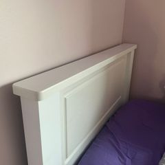 Solid white single bed frame.