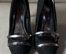 Black high heeled shoe with silver detail front