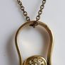 Vintage necklace features a polished, knocker-shaped pendant  gold plated, centered with an iridescent turquoise Spinning Fob Image 6
