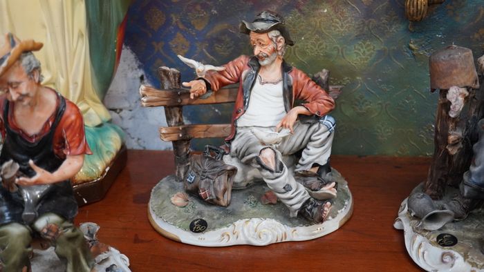 Porcelain Figurine of Seated Elderly Man with Birds
