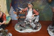 Porcelain Figurine of Seated Elderly Man with Birds