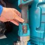 The Makita GA004G 115mm 40V XGT grinder with battery and charger Image 3