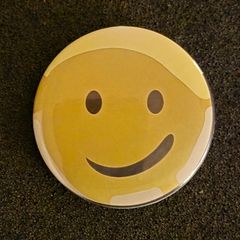 Smiley face, pin back button badge.