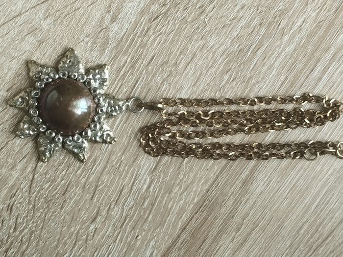Vintage pendant on a long chain.