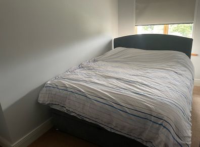 Upholstered grey double bed base with storage and headboard