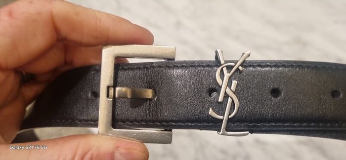 Black leather belt in the style of designer