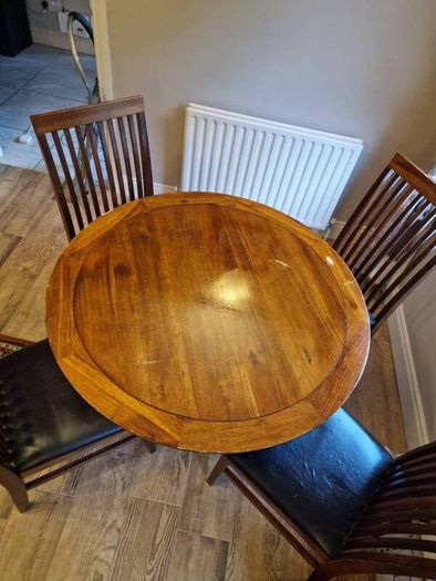 Round wooden table and four chairs