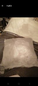 2 grey fur/fluffy cushions