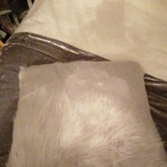 2 grey fur/fluffy cushions