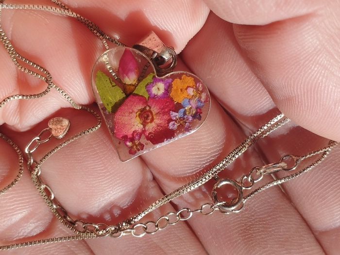 Handcrafted 925 sterling silver necklace with a heart-shaped pendant featuring a floral pattern.