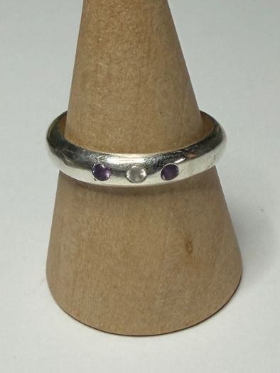Handmade sterling silver ring with flush set stones. Size O