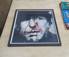 framed Leonard Cohen picture.