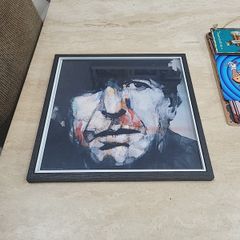 framed Leonard Cohen picture.