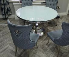 White round glass table with four chairs