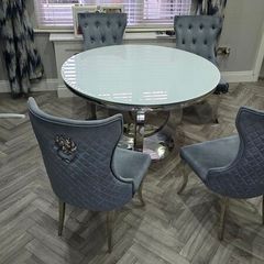 White round glass table with four chairs