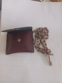 Title: Authentic Jerusalem Olive Wood Rosary & Leather Case  Description: Selling an authentic Catholic rosary made from Holy Land olive wood beads. The back of the crucifix is stamped "JERUSALEM", and the center medal is stamped "TERRA SANTA" with a 