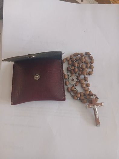 Title: Authentic Jerusalem Olive Wood Rosary & Leather Case  Description: Selling an authentic Catholic rosary made from Holy Land olive wood beads. The back of the crucifix is stamped "JERUSALEM", and the center medal is stamped "TERRA SANTA" with a 