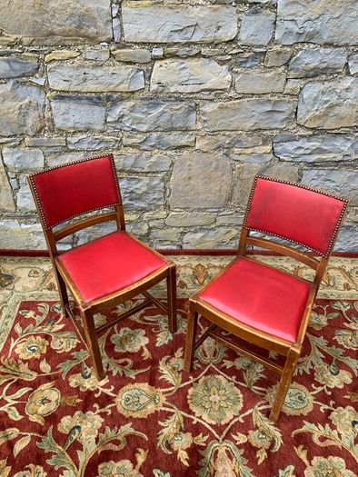 A pair of mid century leatherette kitchen chairs.