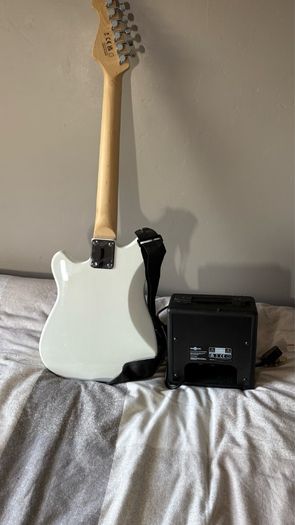 White electric guitar with amp box used only twice