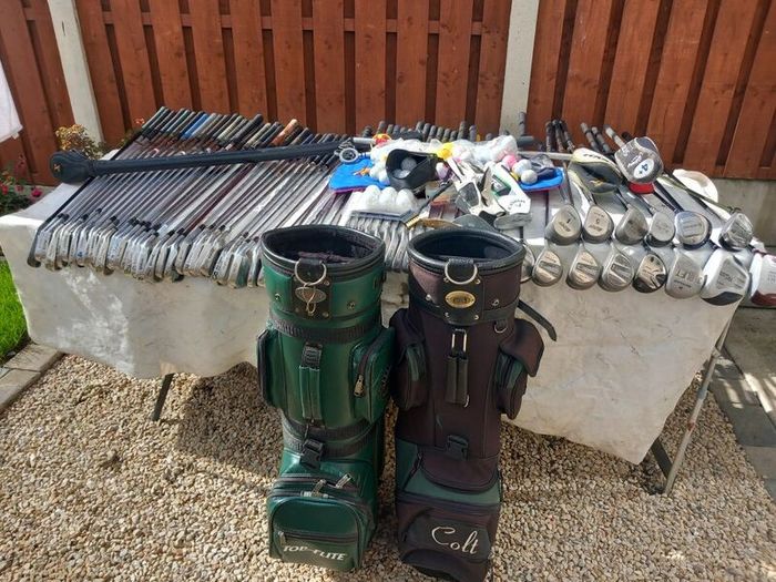 A selection of Golf clubs. Bags and golf balls.
