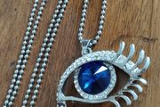 Vintage beautiful blue eye pendant on a long chain.