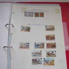 A collection of stamps from Isle of Man and Israel on albums pages (1950-1998) in the binder
