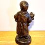 Boy Statue in a Home Dress with Bear Toy & Books. Image 3
