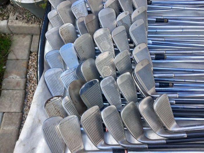 A selection of Golf clubs. Bags and golf balls.