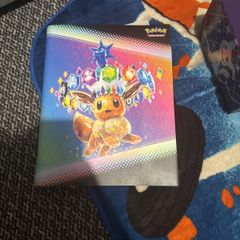 pokemon cards and book and sleeves and game thing
