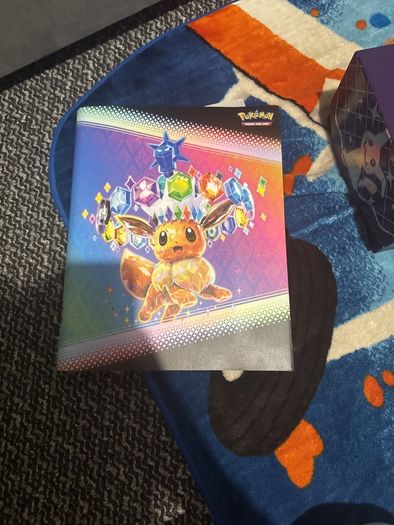 pokemon cards and book and sleeves and game thing